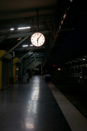 Ceiling clock in the train station at nightの写真素材