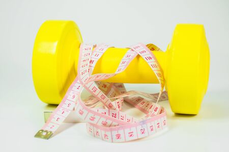 diet concept, dumbbell and measuring tape の写真素材
