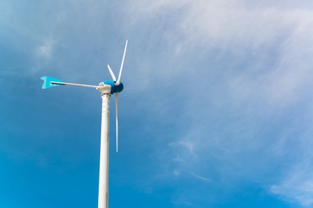  white wind turbine generating electricity on blue sky