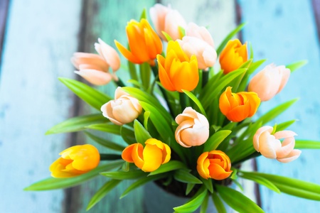 colorful of artificial tulip flower on the vintage table
