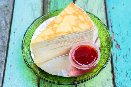 Crepe cake with strawberry sauce