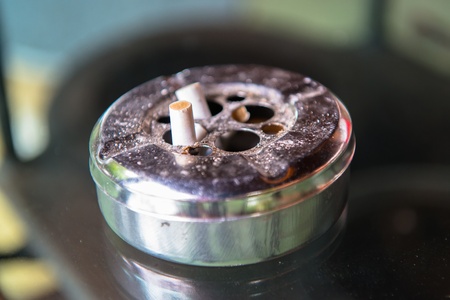 butt cigarette , ashtray grunge background 