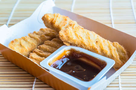 Fried chicken pieces with sauceの写真素材