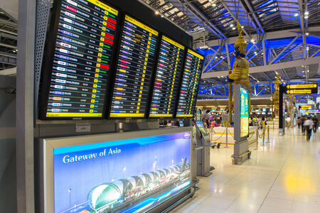 BANGKOK - APRIL 4  Passengers checking the flight schedule on airport charts at Suvarnabhumi Airport , on 4 April, 2014 in Bangkok, Thailandのeditorial素材