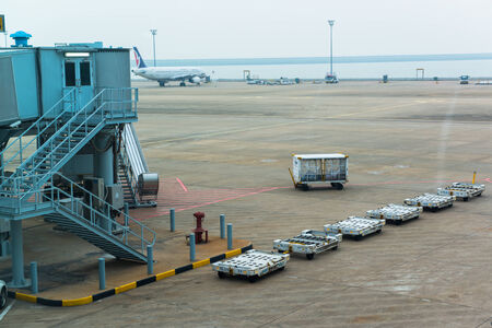 Japan - Circa 2014:  landing airplanes, waiting for takeoff permission aircrafts on runway, loading and unloading luggage at Narita International Airport, Japanのeditorial素材