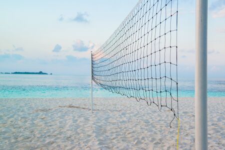 Torn beach volleyball net at tropical beachの写真素材