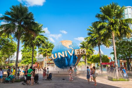 SINGAPORE - JANUARY 13 Tourists and theme park visitors taking pictures of the large rotating globe fountain in front of Universal Studios on January 13, 2015 in Sentosa island, Singaporeのeditorial素材