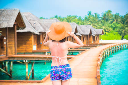 Woman is relaxing on the water bungalow of the tropical beach, Maldivesのeditorial素材