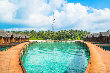 Over water bungalows with steps into amazing green lagoonのeditorial素材