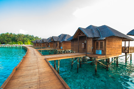Over water bungalows with steps into amazing green lagoonのeditorial素材
