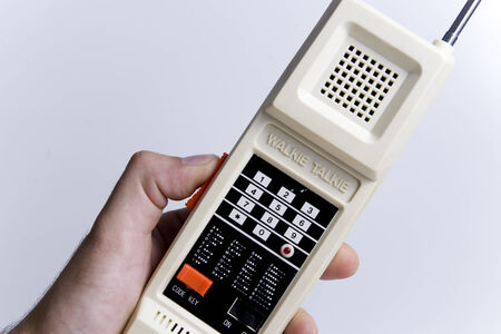 A retro radio hold by a human handの写真素材