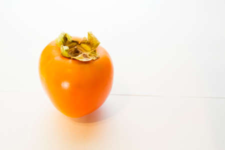 Ripe persimmon fruit on a white background. Healthy food.の写真素材