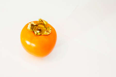 Ripe persimmon fruit on a white background. Copy space.の写真素材