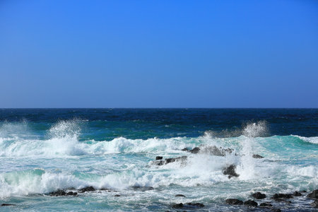 Cool waves crashing at Yongdam Beach in Jeju Island