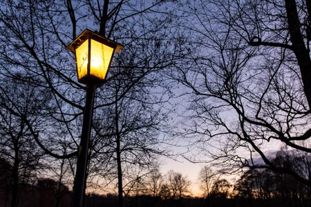 Yellow lantern in front of blue sky during blue hour