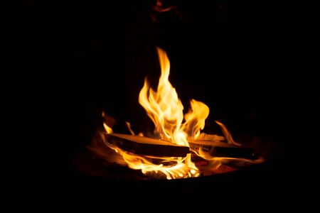 Warm orange bonfire with pieces of wood