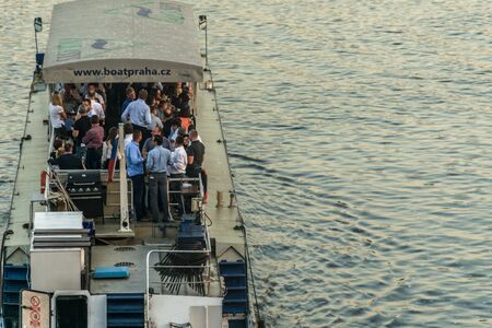 Happy hour in Tourist boat in the evenning on a tour on the Vltava river, with the moon, rising in the skyのeditorial素材