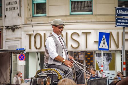 Vienna, Austria - September , 15, 2019: Carriage driver leads through the streets of Vienna surrounded by traffic signsのeditorial素材