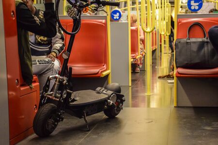 Vienna, Austria - September , 16, 2019: People, a motorized scooter and dogs are passengers inside a...