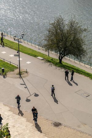 Krakow, Poland - September 23, 2018: Pathway with pedestrians walking besides the Vistule river in...