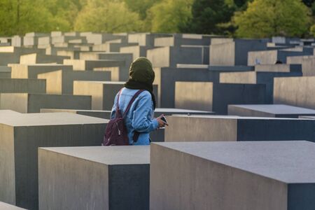 BERLIN, GERMANY - SEPTEMBER 26, 2018: Woman walks trought blocks of the Memorial to the Murdered...