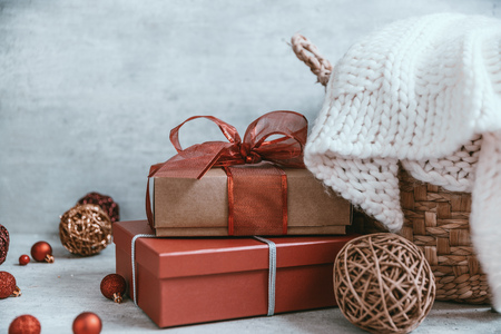 Beautiful Christmas background with decorations and gift boxes on wooden board. Red ribbon, pine cones, baubles. Copy space, greeting card.の写真素材