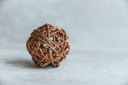 Golden glitter christmas ball on wooden background with white copy space. Winter greeting card.の写真素材
