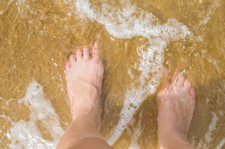 Great vacation concept, woman feet in the sand on the beach.の写真素材