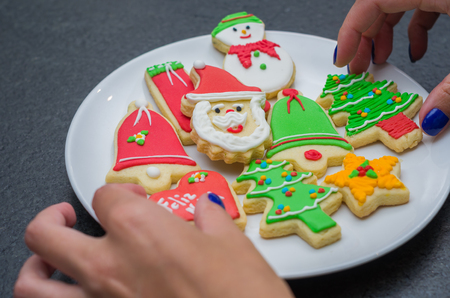 Great christmas background, christmas biscuits on white plate with black backgroundの写真素材