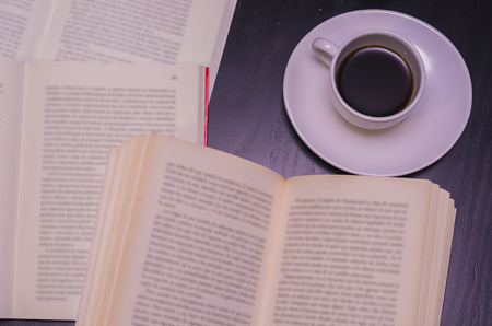 Reading a book and drinking coffeeの写真素材