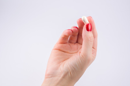 Hands of woman with prescription pills on the palm medical treatment.の写真素材