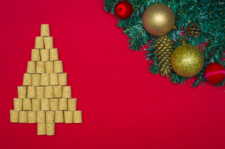 Background with christmas theme, christmas tree with wine corks on red background and decorative objects.の写真素材