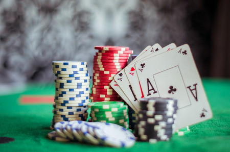Stack of chips and four aces