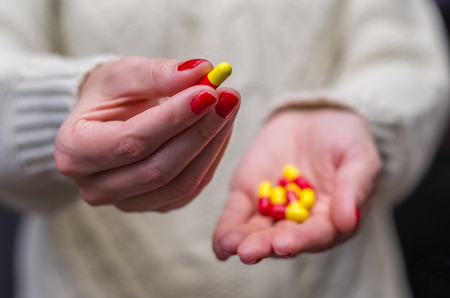 Woman in winter clothes with medicines.