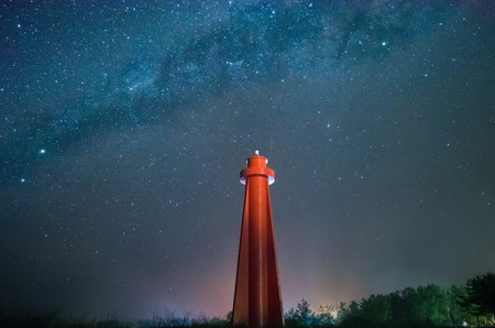 Lighthouse with Milky Way behind.Long exposure photograph of the center of Milky Way, 14 km south of Lighthouse Beach, a very dark and iso.の写真素材
