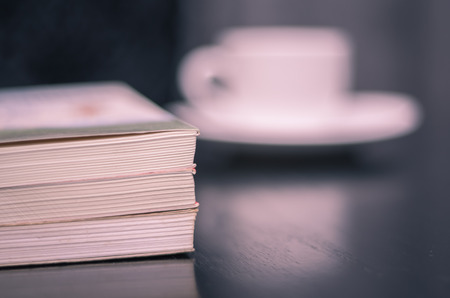 Reading a book and drinking coffee