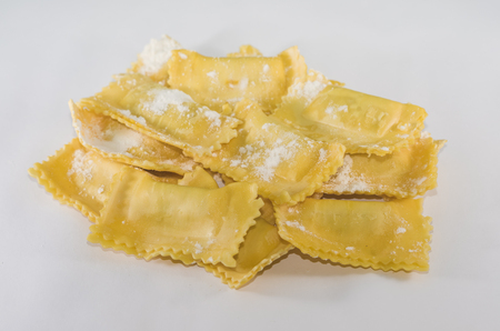 Ravioli and parsley powdered with wheat flour on the granite tableの写真素材