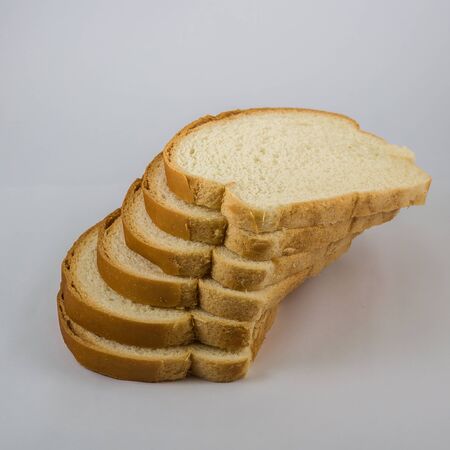 Bunch of slices of bread sandwich on white backgroundの写真素材