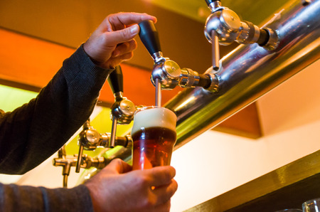 Beer taps on bar counter, brewpub. Craft beer.