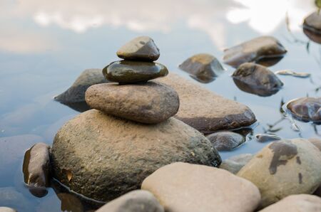 Great concept of spiruality, tranquility and meditation, land art with stones in waterfall.の写真素材