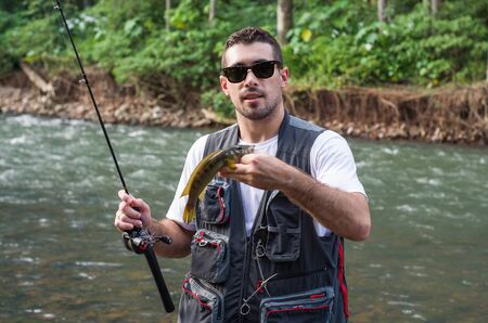 Young man practicing sport fishing in Rio de Janeiro, fishing JacundÃ¡.