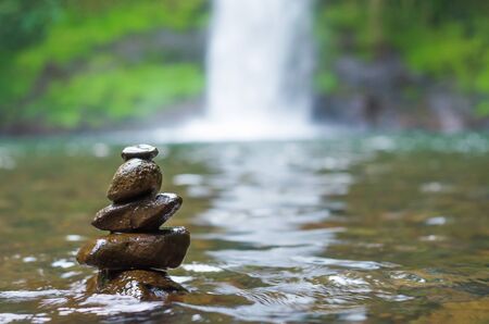 Great concept of spiruality, tranquility and meditation, land art with stones in waterfall.の写真素材