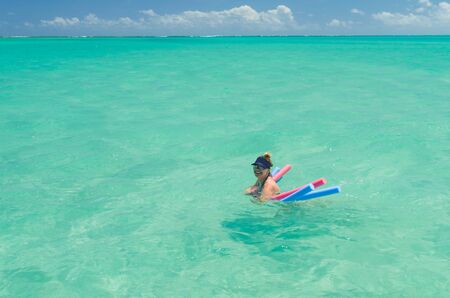 Young blonde tourist taking a sea bath in paradise beach of Maragogi, Brazil.の写真素材