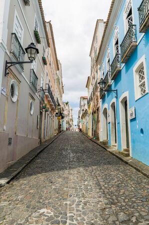 Salvador, Brazil  - Novemberl 11, 2019: Bright sunny view of the historic tourist center of Pelourinho, Salvador da Bahia, Brazil featuring colorful colonial architecture on a broad cobblestone hillの写真素材