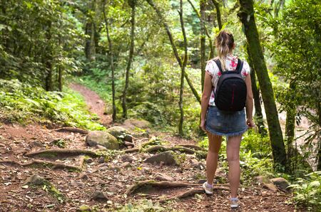 Great concept of trail, back view of young woman walking.の写真素材