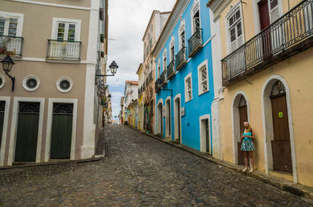 Salvador, Brazil  - Novemberl 11, 2019: Bright sunny view of the historic tourist center of Pelourinho, Salvador da Bahia, Brazil featuring colorful colonial architecture on a broad cobblestone hillのeditorial素材