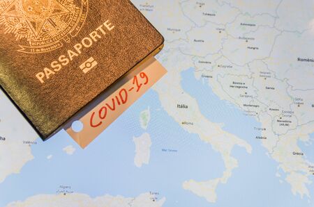 Coronavirus epidemic and travel restrictions in europe concept. The note COVID-19 and Brazilian passport on map with Europe. Novel coronavirus outbreak. Border control of tourists infected with coronavirus.の写真素材