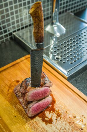 Beautiful photo of beef brisket (Brisket point end). Meat cut with forged Damascus steel knife Arkansas Breeze style.の写真素材