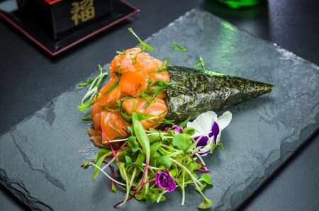 Sushi. Traditional Japanese cuisine, premium salmon Temaki decorated in an elegant setting.の写真素材