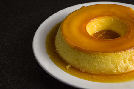 Traditional Brazilian dessert, milk pudding on dark background.の写真素材
